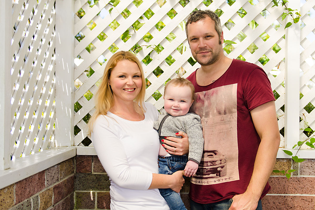 outdoor family portrait - dad, mom, and one year old son