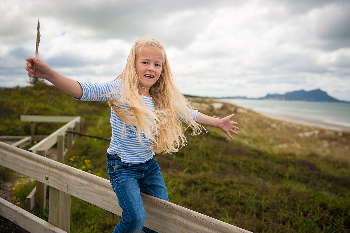 children portrait captured during overcast day on the beach, whangarei nz