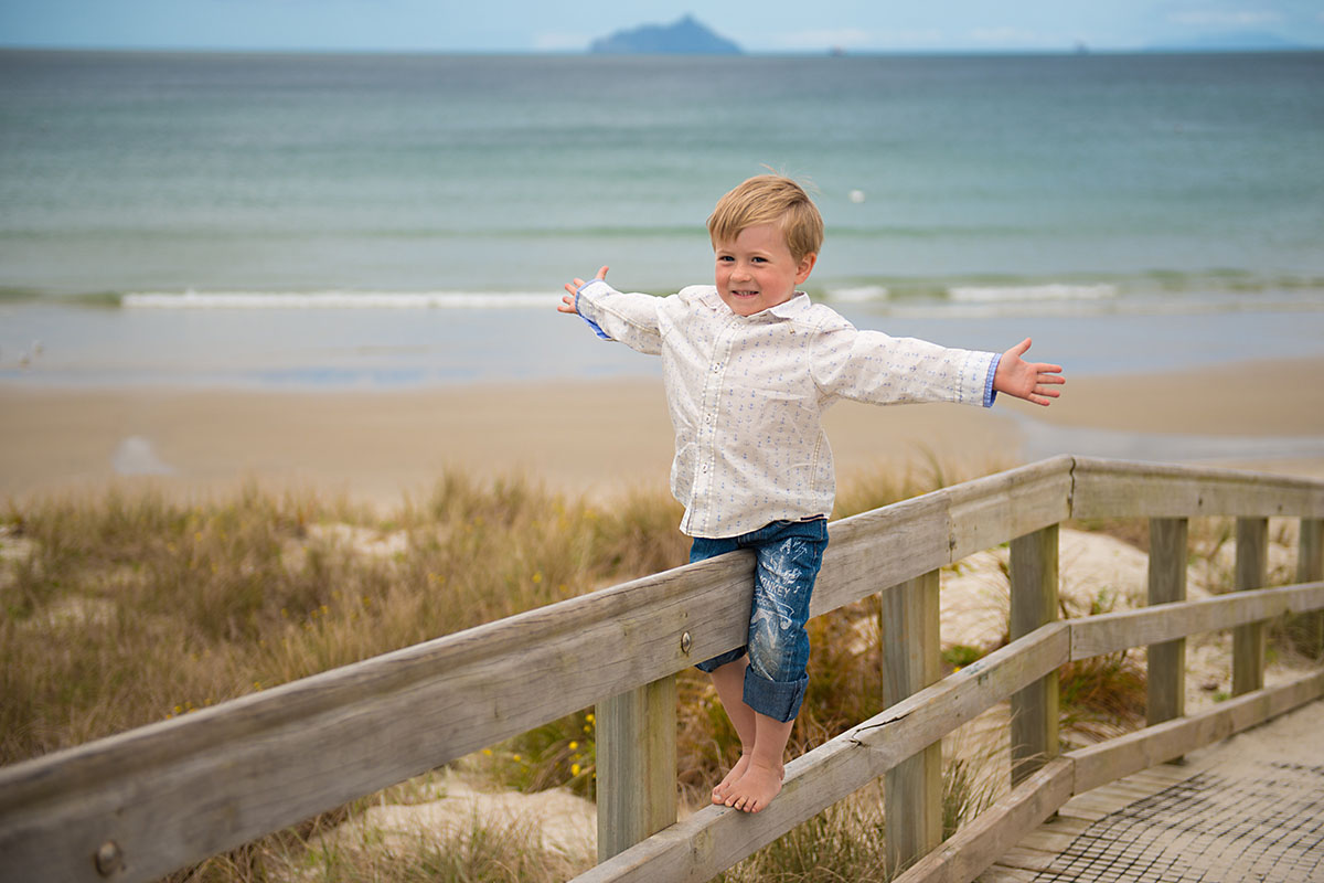 portrait of the boy captured during overcast day on the beach by angelika thorn photogrpahy