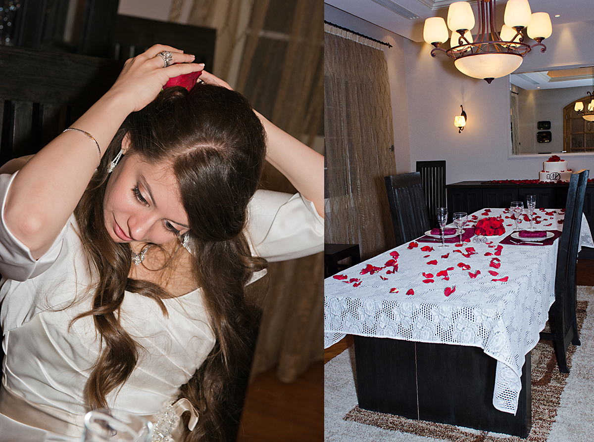 bride is putting red flower in her hair