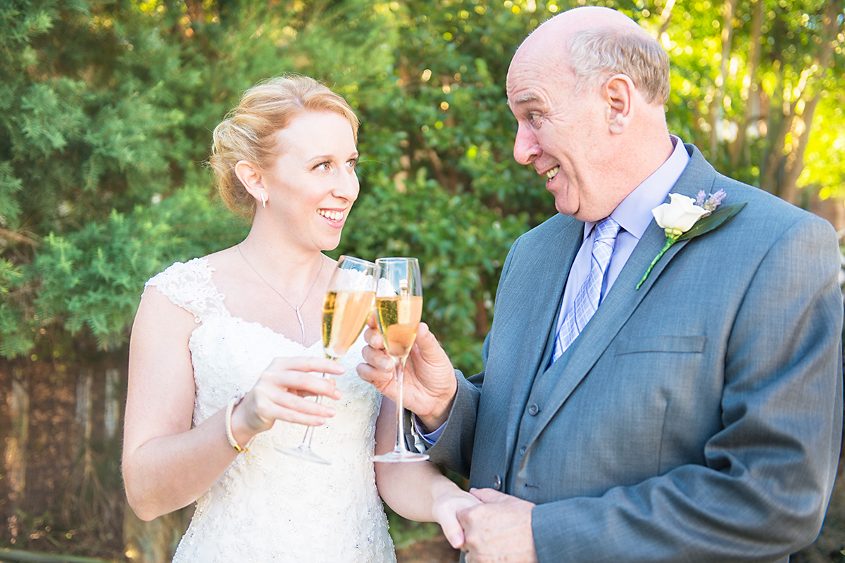 bride and her dad having a glass of champagne before the wedding ceremony NZ